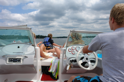 A woman sitting on the back of a boat.