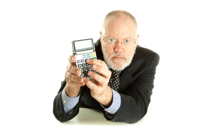 A man in a suit and tie holding a calculator.