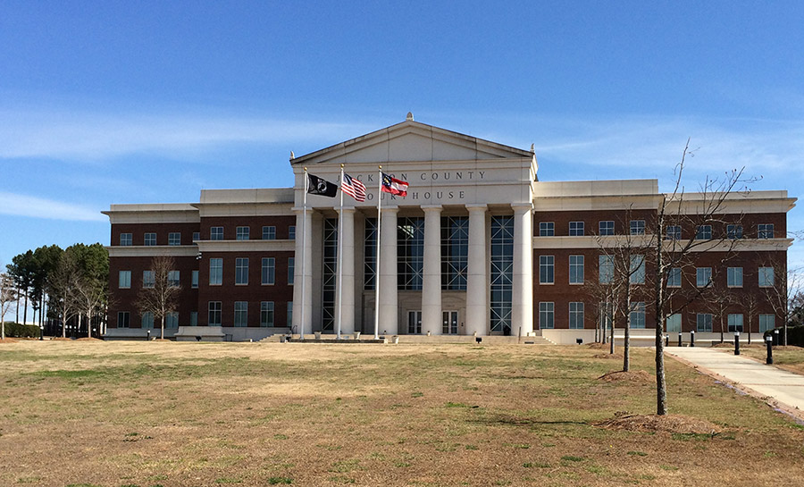 A large building with columns and flags on the front.