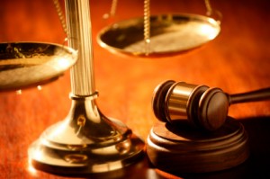 Brass scales of justice with wooden gavel
